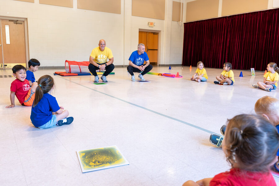 Children seated in a circle as Ready Set Fit coaches lead the class