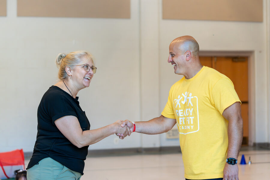 A Ready Set Fit coach shaking hands with a preschool director